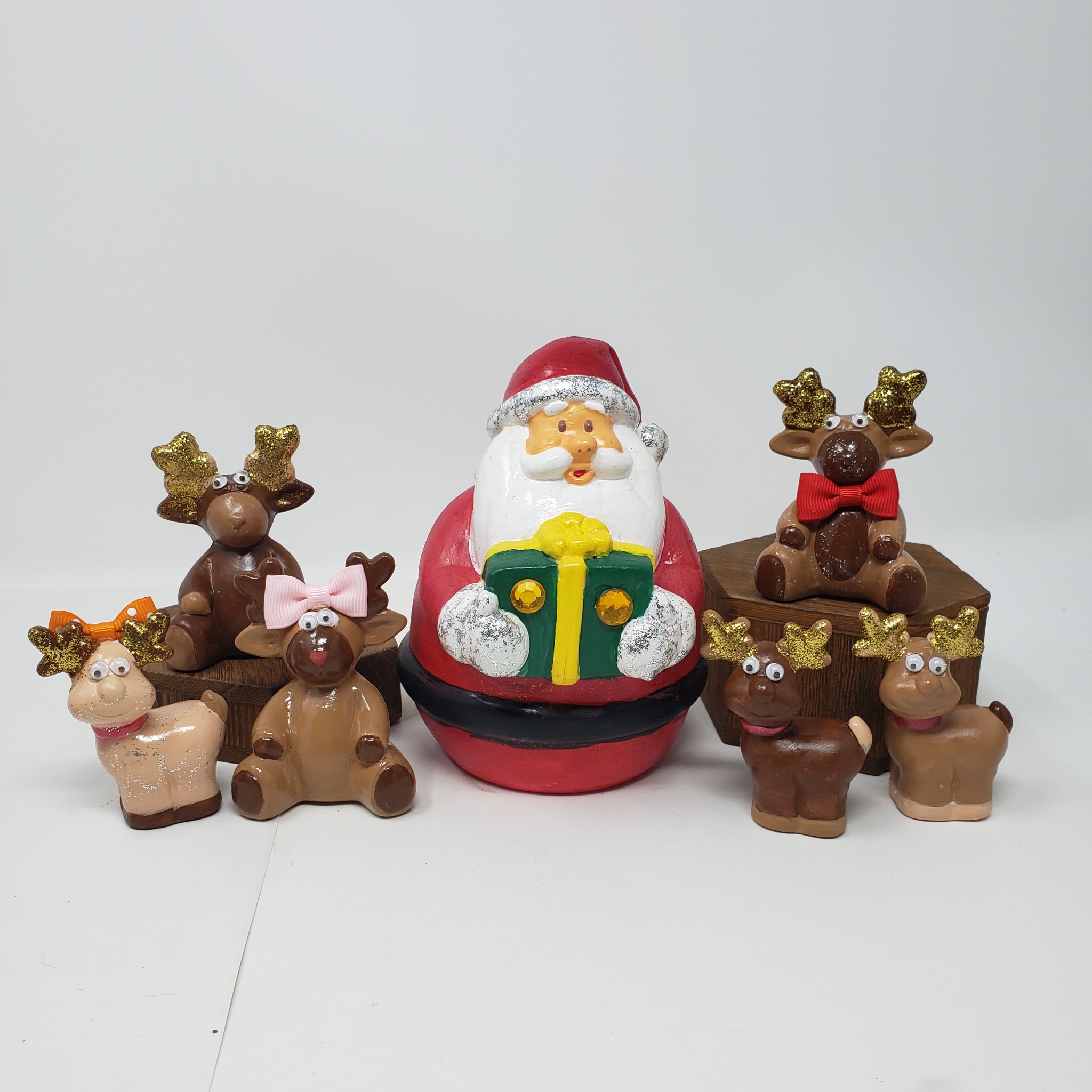 Painted Santa and reindeer ceramic pieces